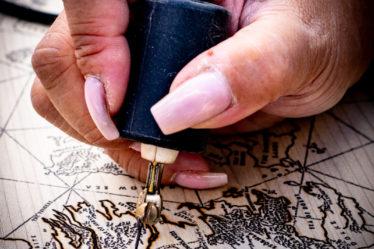 Close up of a person burning map on wood