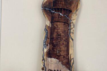 A lighthouse and fractals burned on wood