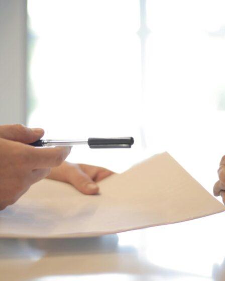 Two people signing a contract