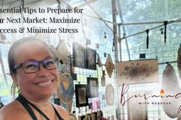 “Artist setting up a wooden art display booth at a local market.”